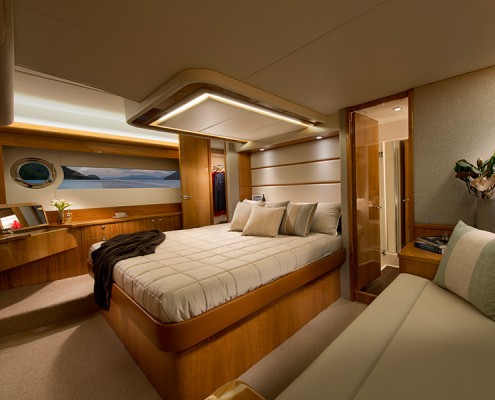 Riviera 565 - The 565 SUV's stately full-beam master stateroom features a king island bed, large hull windows and optional opening port holes for cross ventilation