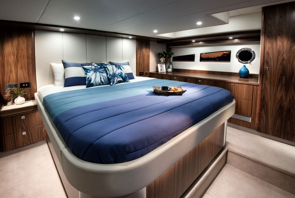 Hull windows bathe the luxurious master stateroom in natural light on the Riviera 5400 Sport Yacht_preview