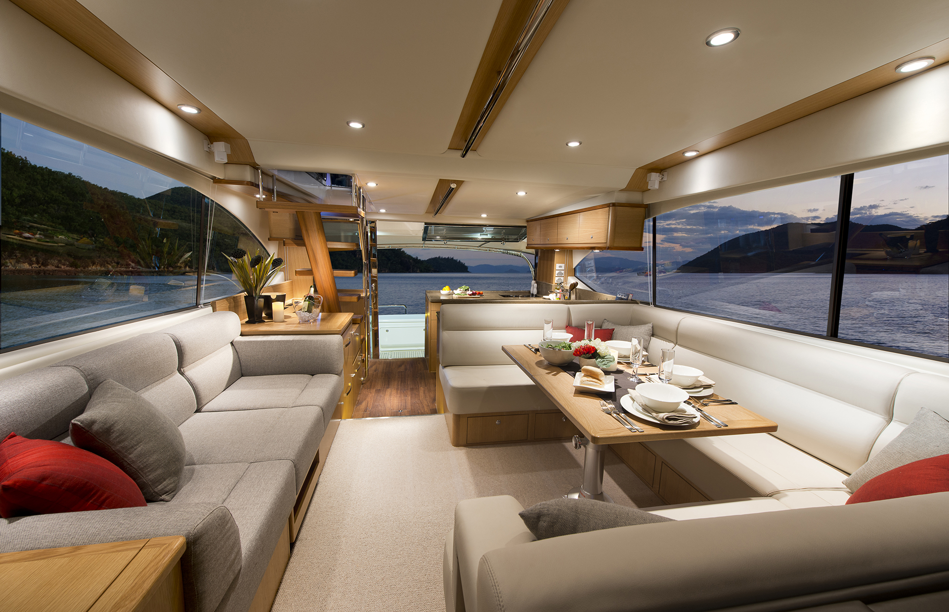 Opening side windows and a massive front windscreen enhance natural light and fresh air in the new 52 Enclosed Flybridge spacious and luxurious saloon